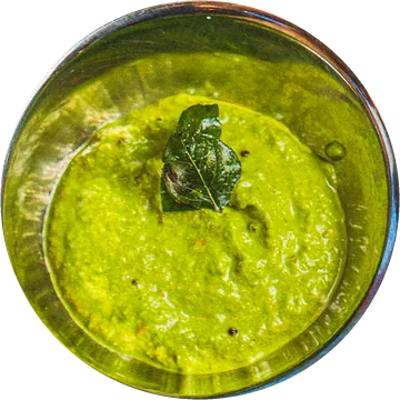 Mint and coriander chutney in a steel bowl