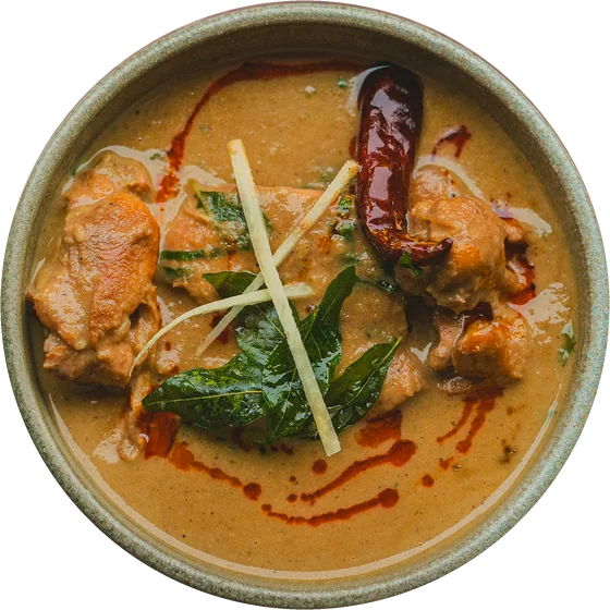 A curry with a dried red chilli and ginger, in a stoneware bowl