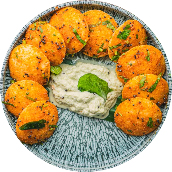 Ghee podi idly round a bowl of coconut chutney