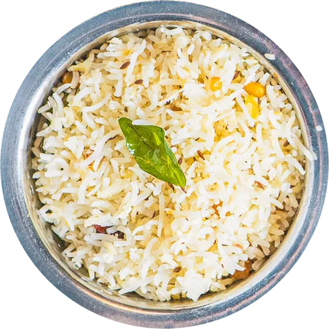 A steel bowl of rice with a curry leaf